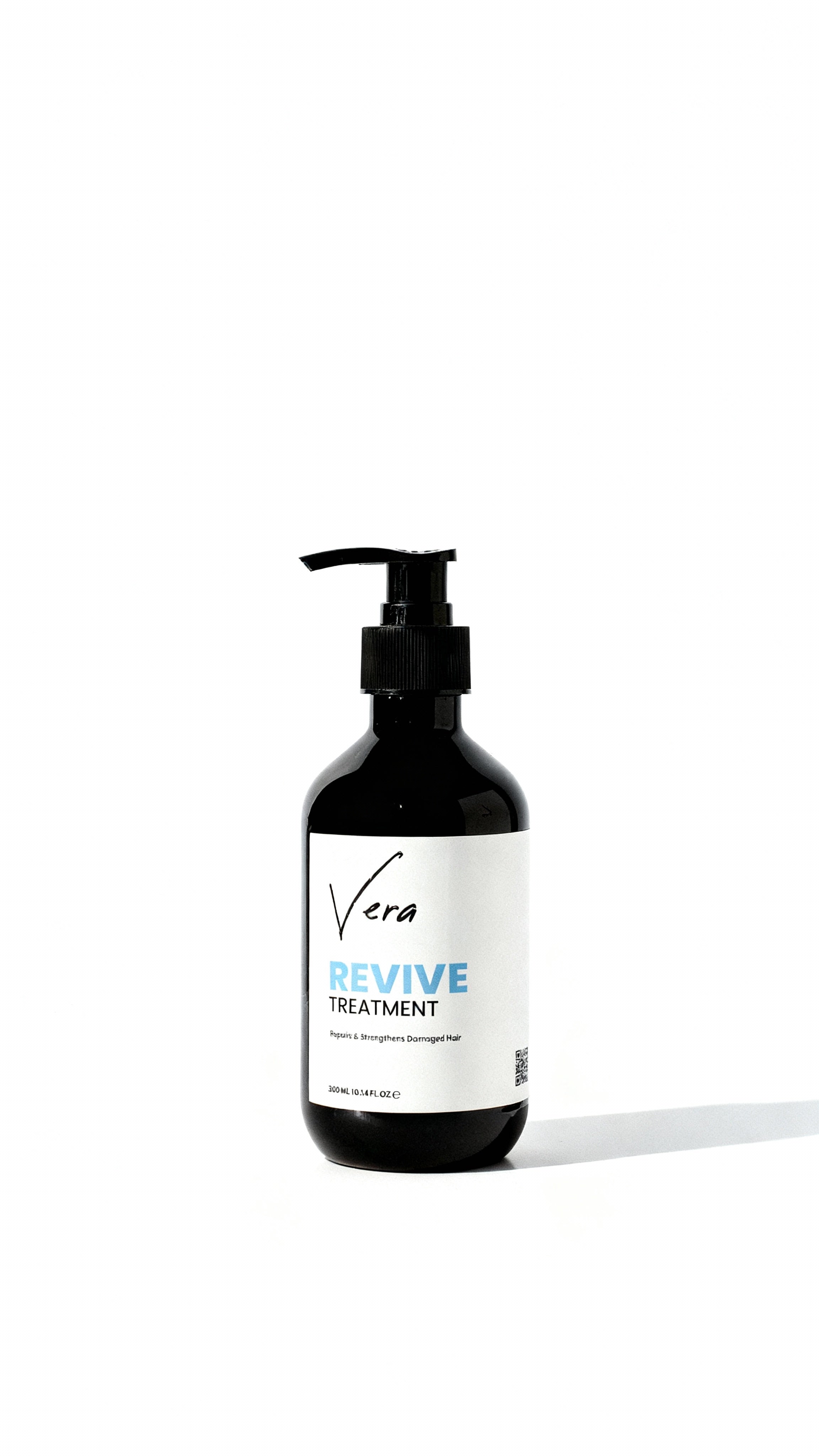 Hair_treatment_bottle_Edit_the_uploaded_photo_of_the_Vera_Revive_Treatment_bottle_to_match_the_lighting_background_and_mood_of_my_reference_product_photo._Keep_the_bottle_pump_and_lab.jpg